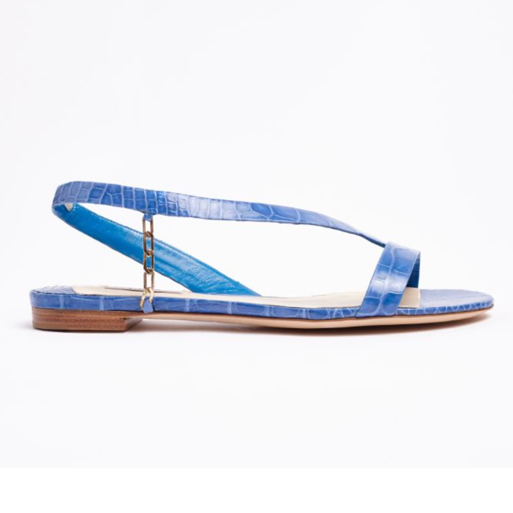Our L’Amazone flat sandal is designed in blue exotic alligator leather to add instant polish and bold color to any outfit.