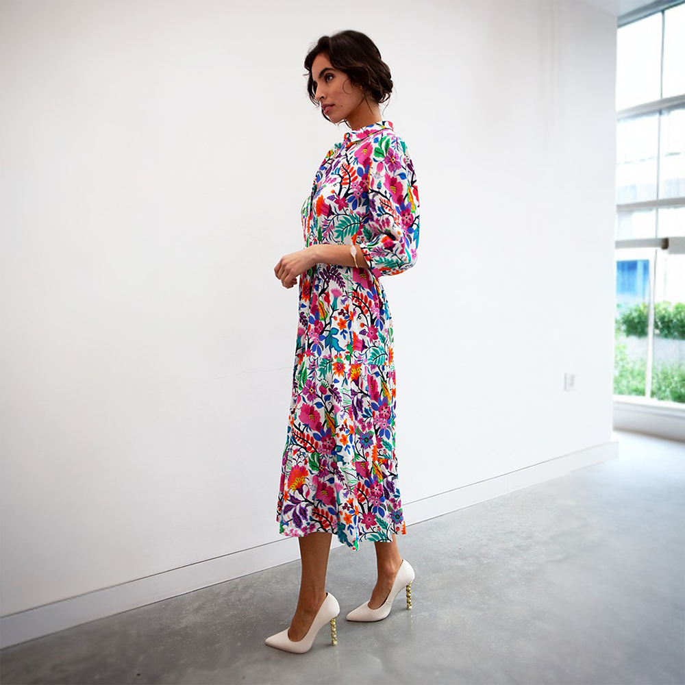 This vibrant printed shirt dress features a colourful floral pattern with three quarter-length sleeves. 