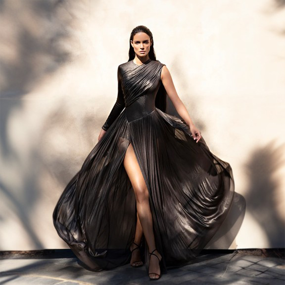 Foiled tulle asymmetric draped dress with falling cape.