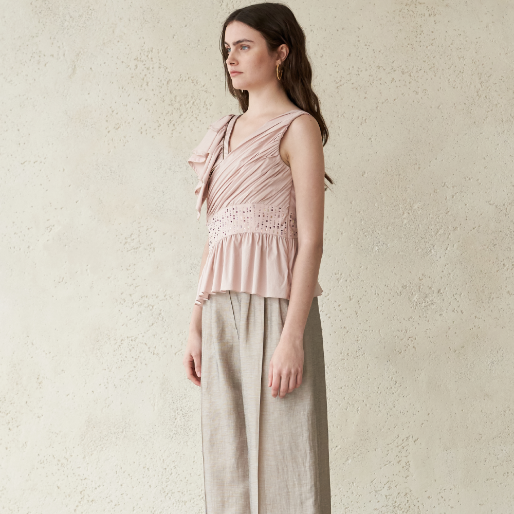 Light pink colored ruffled sleeveless blouse