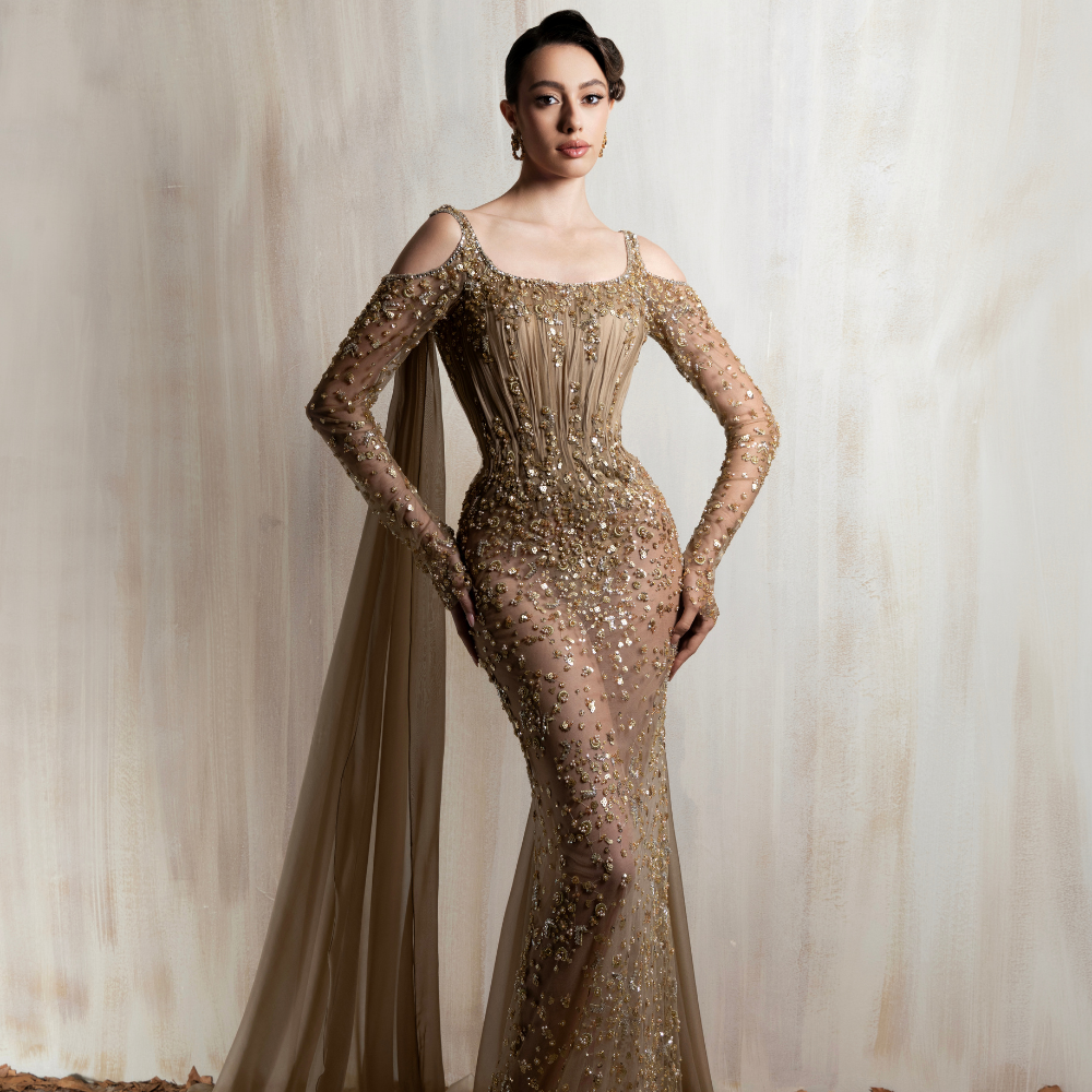 Bronze beaded mermaid gown with sheer sleeves and a muslin shoulder shawl, perfect for elegant occasions. Shop now at our exclusive clothing website.