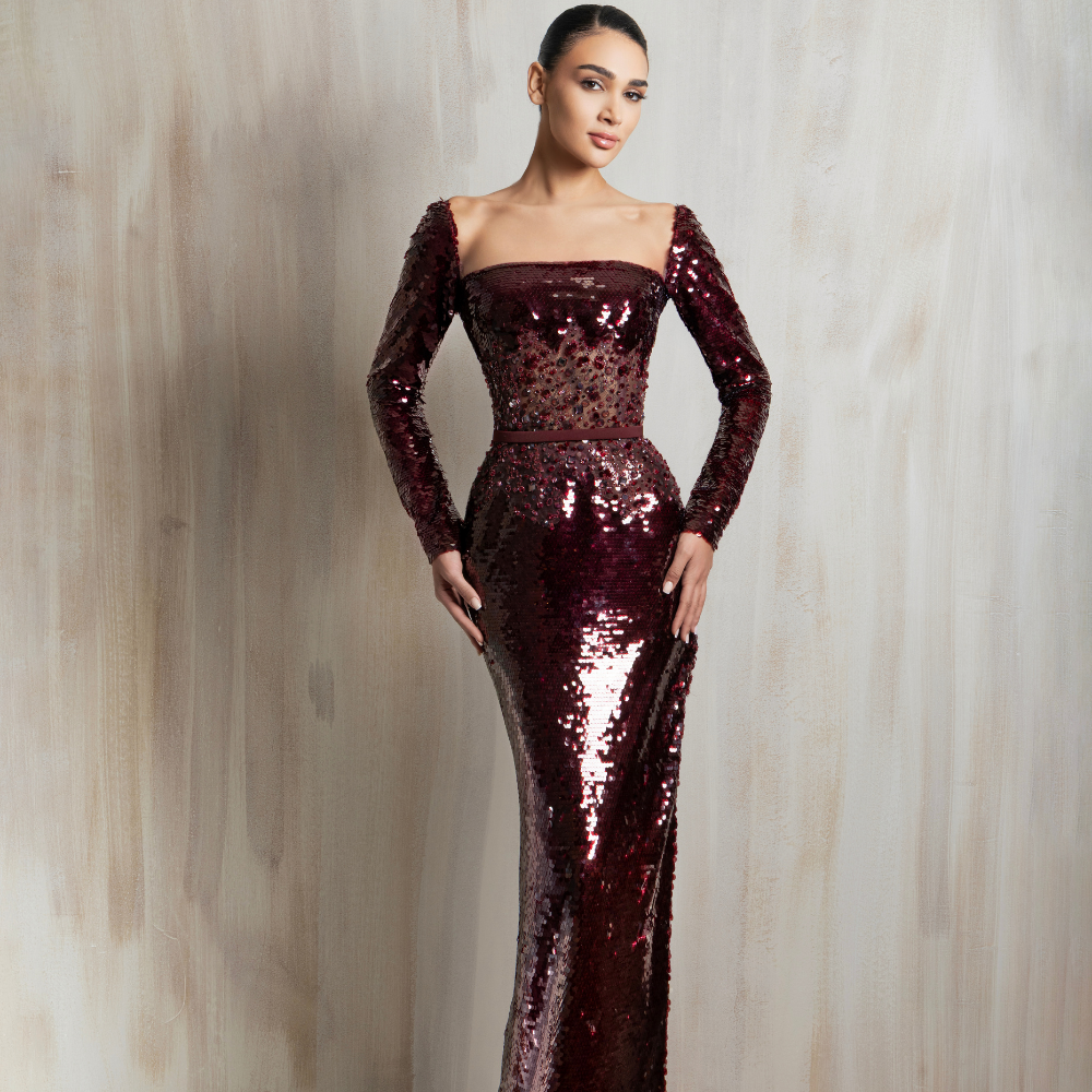 Burgundy sequined long-sleeve gown with a sleek fitted silhouette, perfect for elegant evening wear. Shop now at our exclusive clothing website.