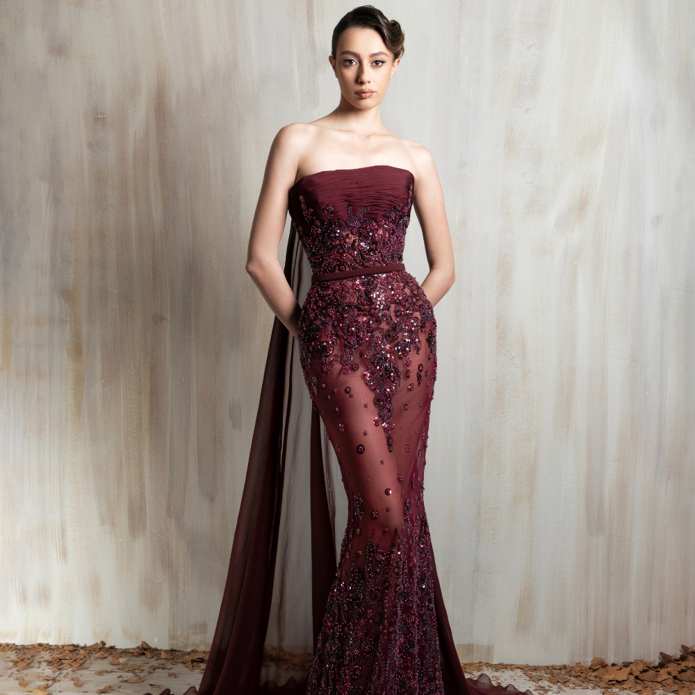Burgundy strapless gown with intricate beading and a sheer train, crafted for elegant occasions. Shop now at our exclusive clothing website.