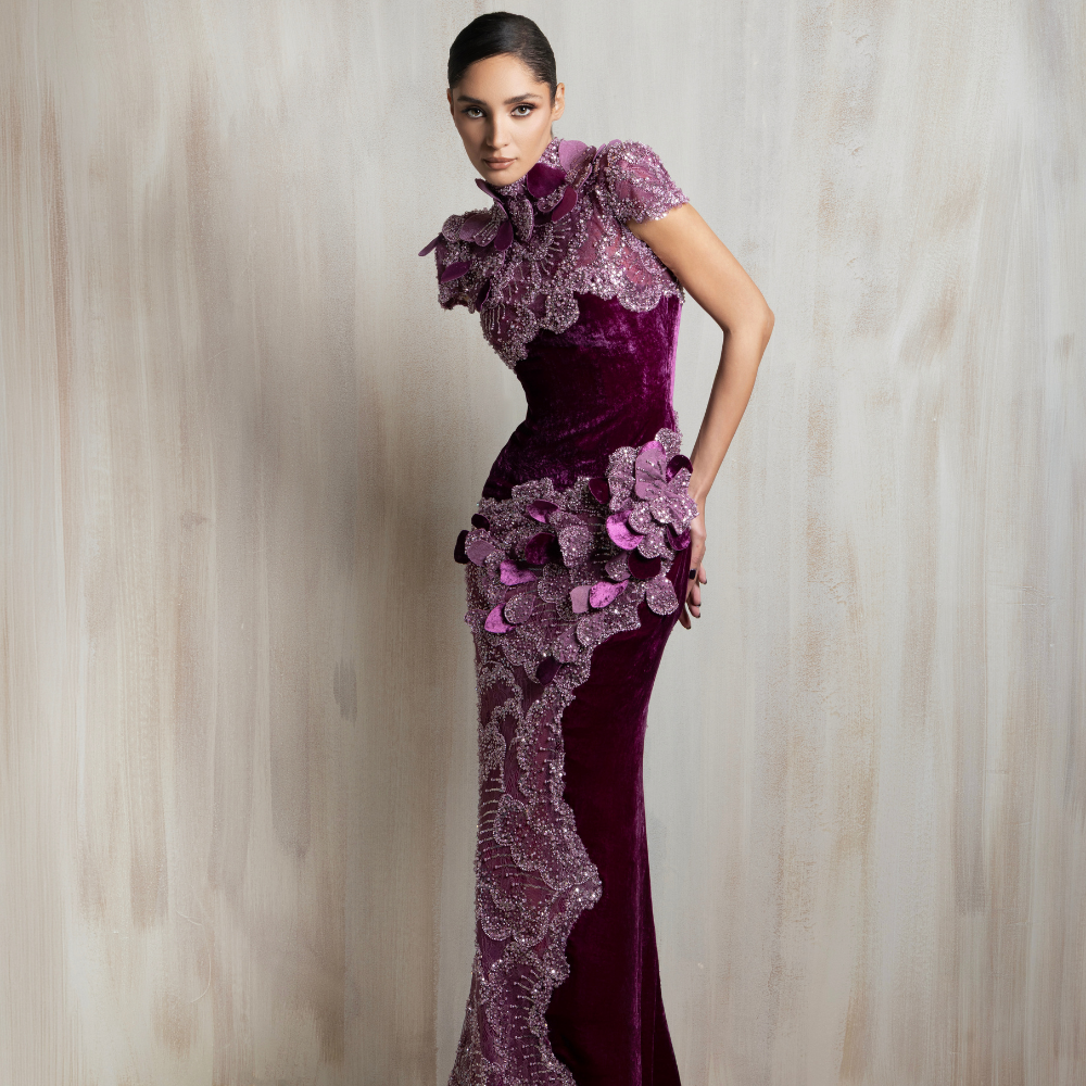 Plum velvet gown with floral embellishments and a sculpted silhouette, crafted for timeless elegance. Shop now at our exclusive clothing website.
