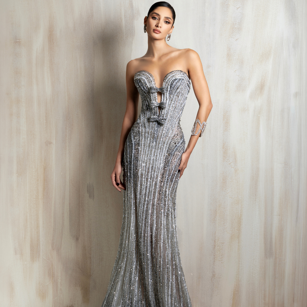 Strapless silver beaded gown with a corset bodice, shimmering details, and a fitted mermaid silhouette. Shop now at our exclusive clothing website.