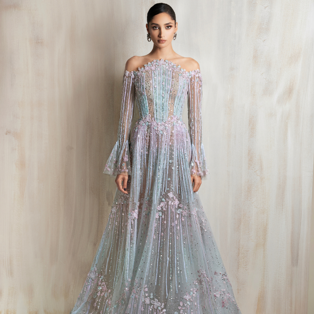 Off-shoulder pastel aqua and pink gown with floral embroidery, beaded details, flared sleeves, and an A-line skirt. Shop now at our exclusive clothing website.