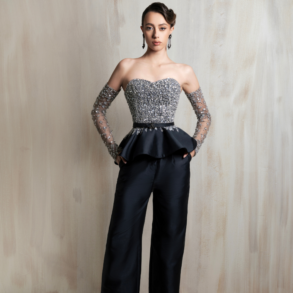 Crystal-embellished bodice paired with tailored black wide-leg trousers, perfect for modern elegance. Shop now at our exclusive clothing website.