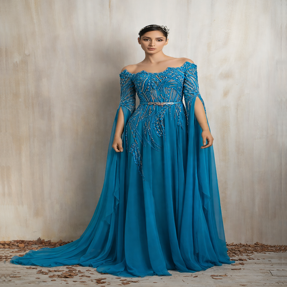 Turquoise embellished gown with a graceful flowing cape, designed for elegant evening occasions. Shop now at our exclusive clothing website.