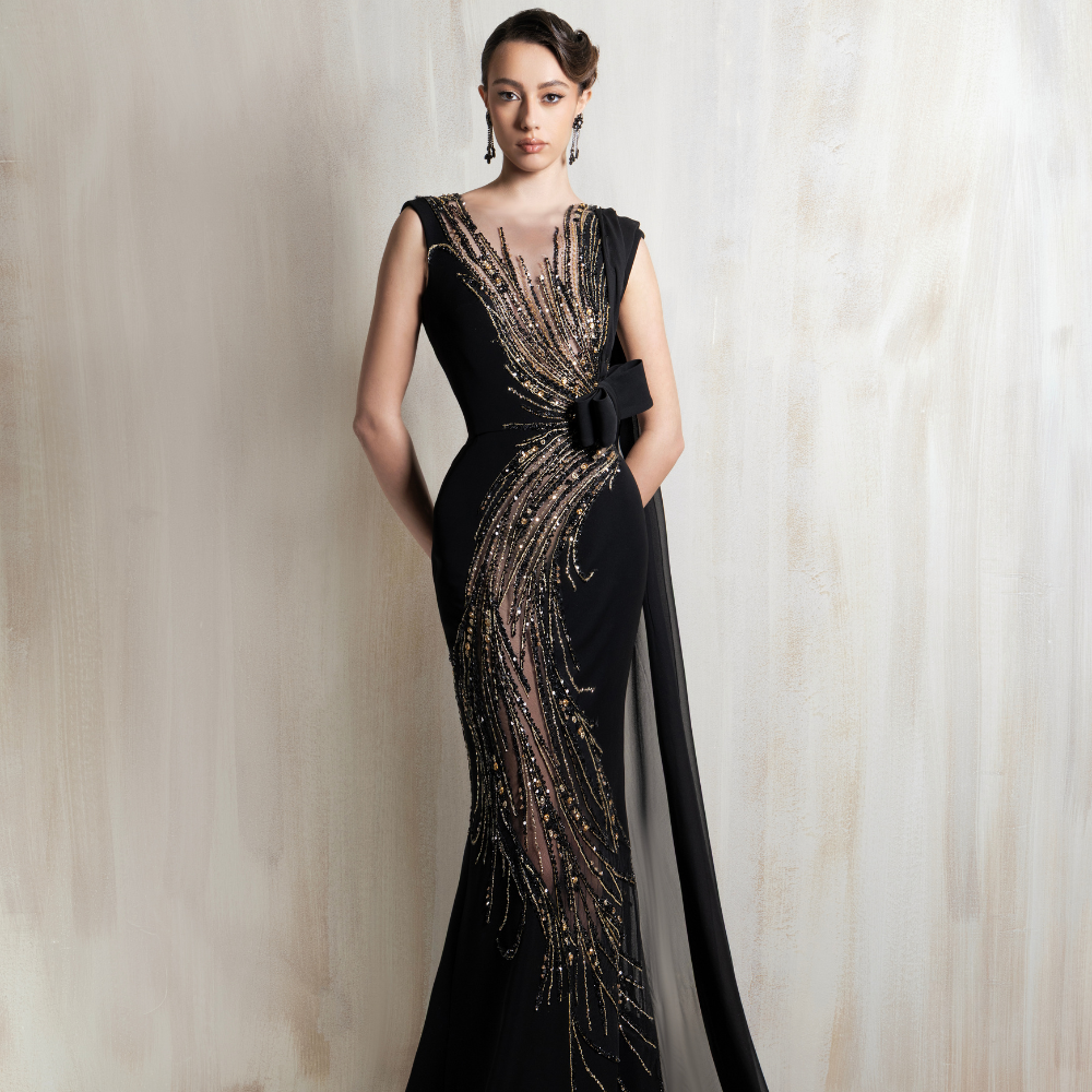 Black gown with golden cascade embroidery and a sleek flowing cape, crafted for glamorous evening events and special occasions. Shop now at our exclusive clothing website.