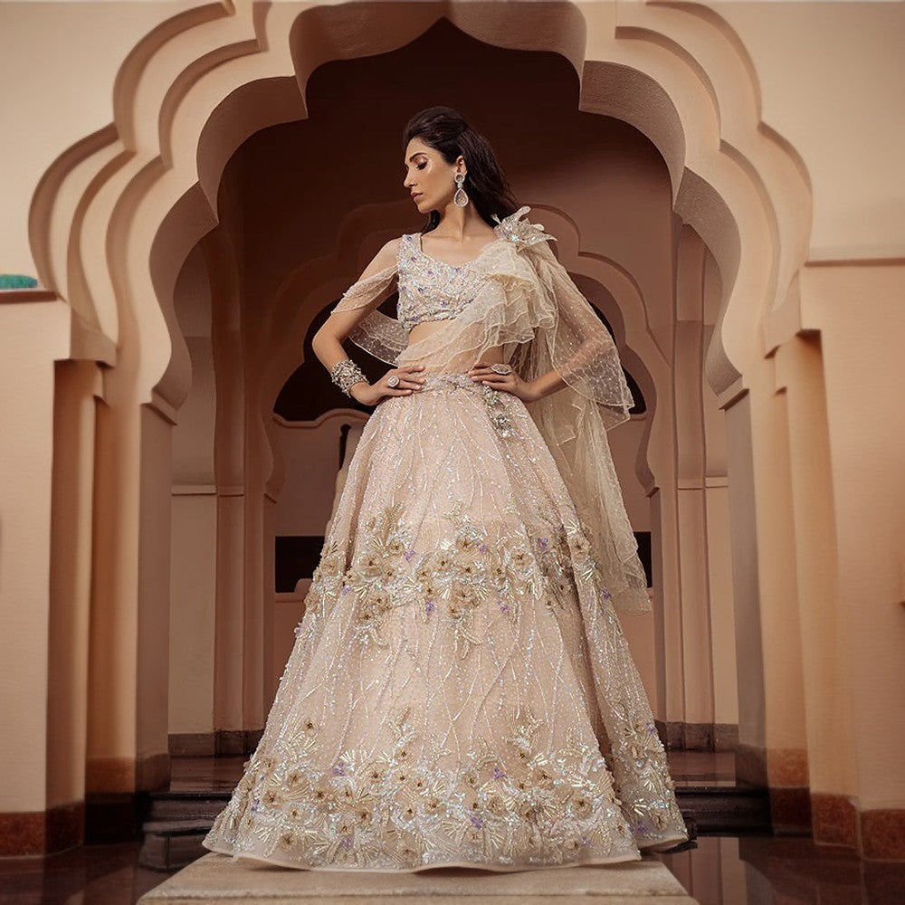 Botanical setting with 3D floral motifs and cosmic shower embroidery all over and multiple drapes dupatta.