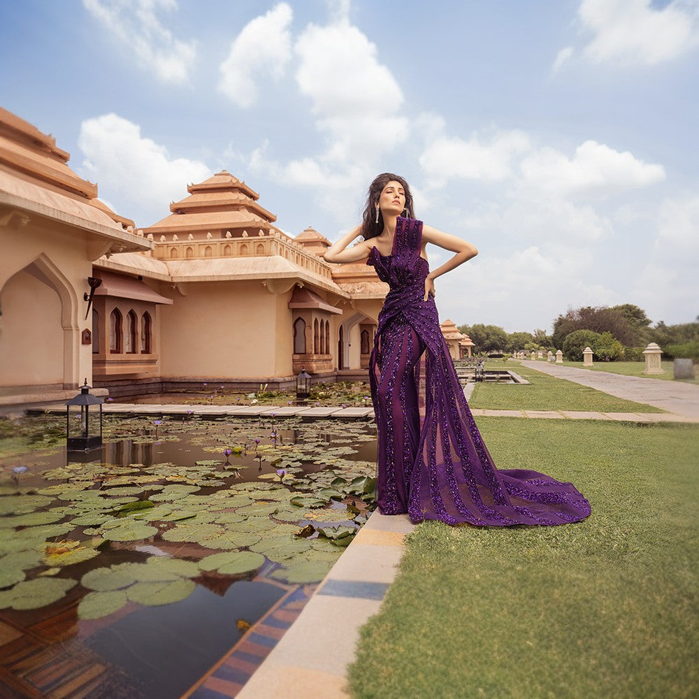 Radiating Aurora bands of lights depicted in this architectural drape gown with wraparound overskirt.