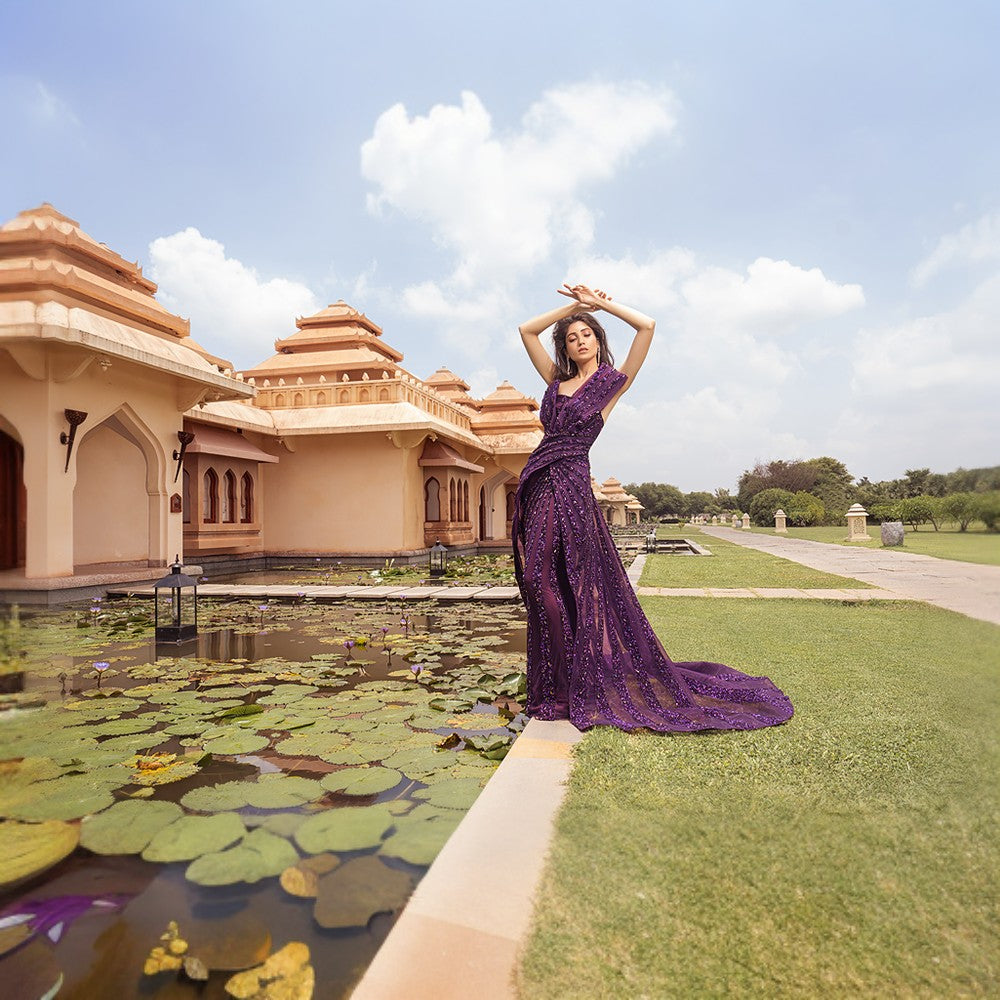 Radiating Aurora bands of lights depicted in this architectural drape gown with wraparound overskirt.