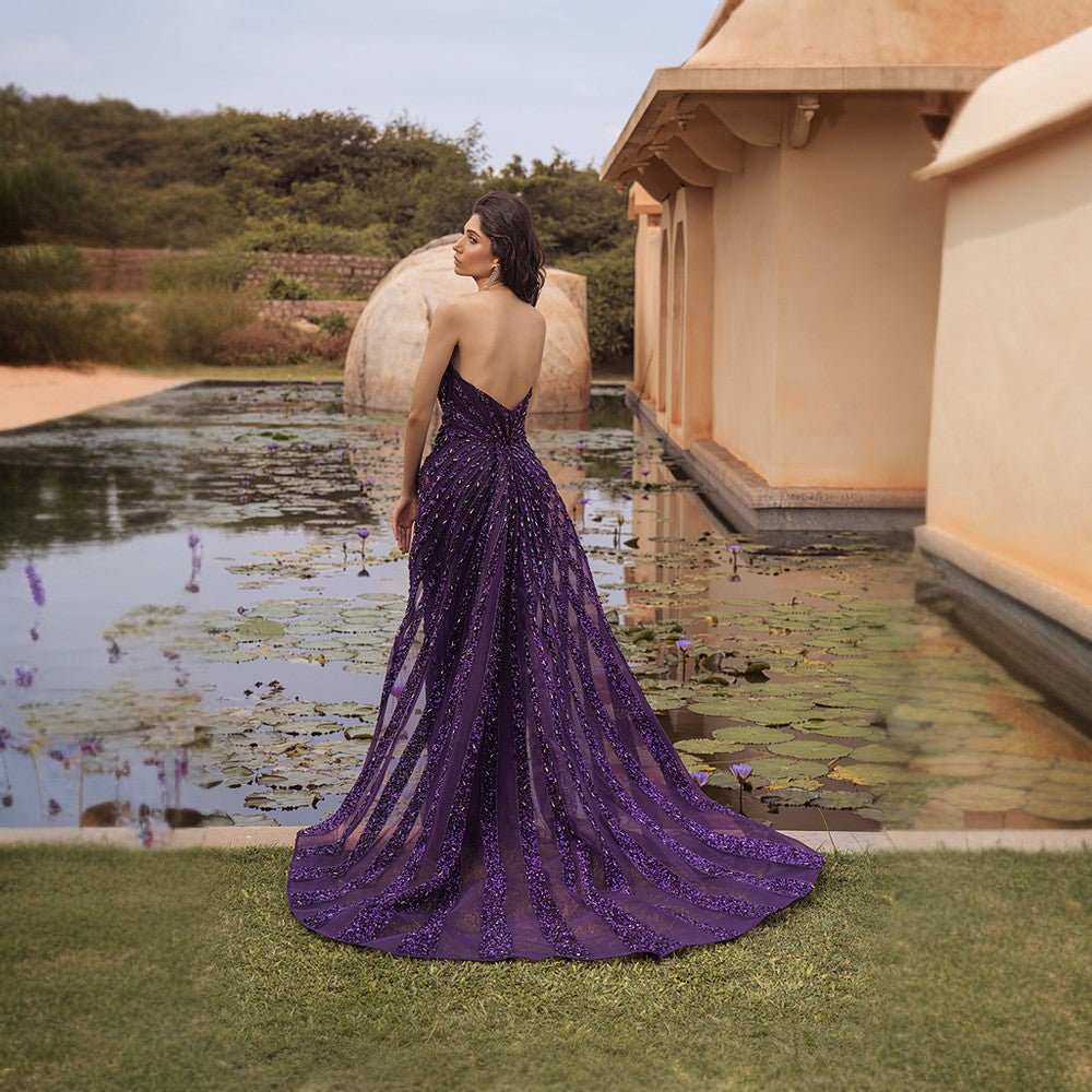 Radiating Aurora bands of lights depicted in this architectural drape gown with wraparound overskirt.