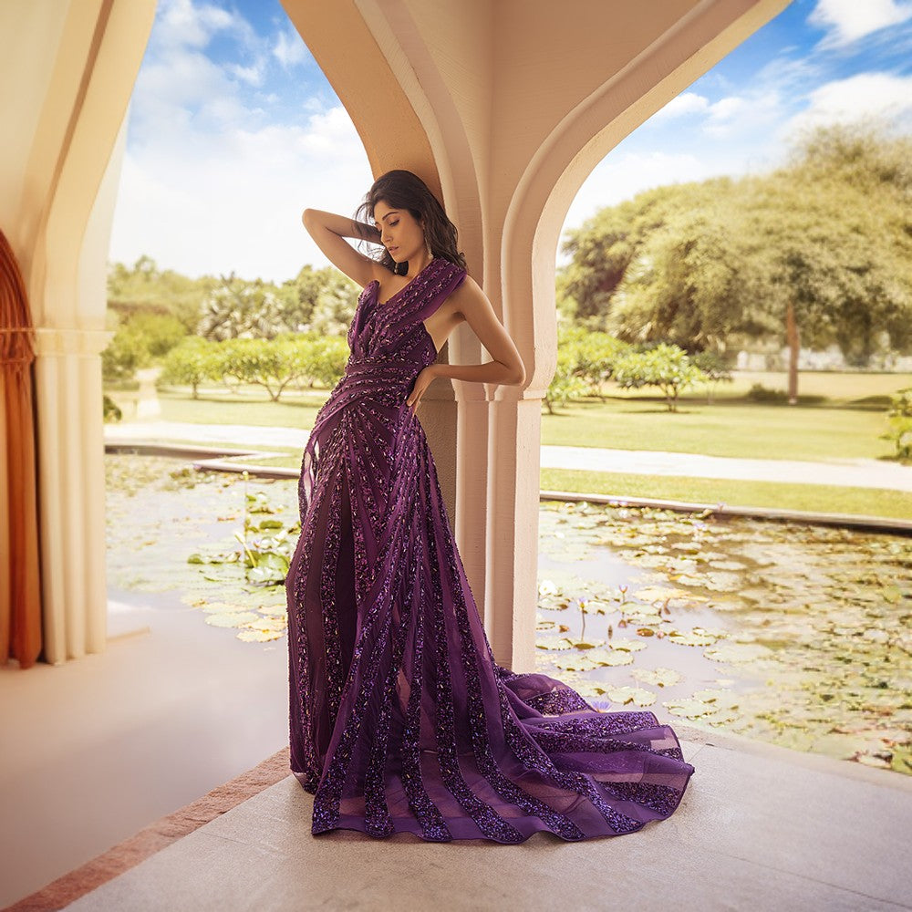 Radiating Aurora bands of lights depicted in this architectural drape gown with wraparound overskirt.