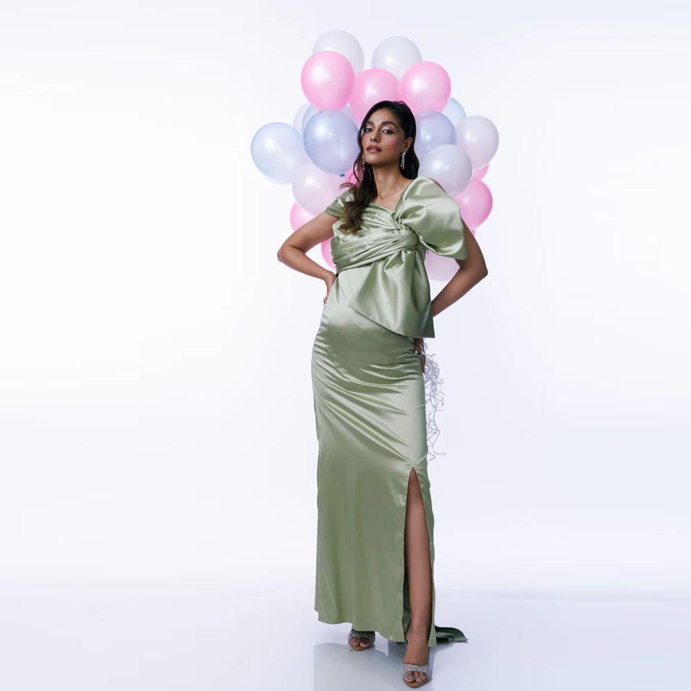 Green satin maternity dress with ruched bust, bow and slit, perfect for events. Shop online from our curated edit of premium fashion.