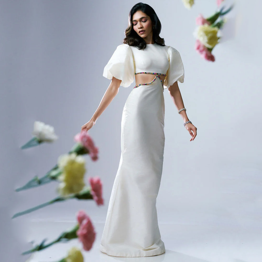 White maxi dress with puff sleeves and rhinestone waist, perfect for events. Shop online from our exclusive collection of premium styles.