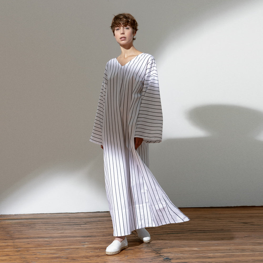Discover the Aya Caftan at The Luxe Maison, featuring an airy, ankle-length poplin design, relaxed wide fit, side pockets, and front and back V-necklines.