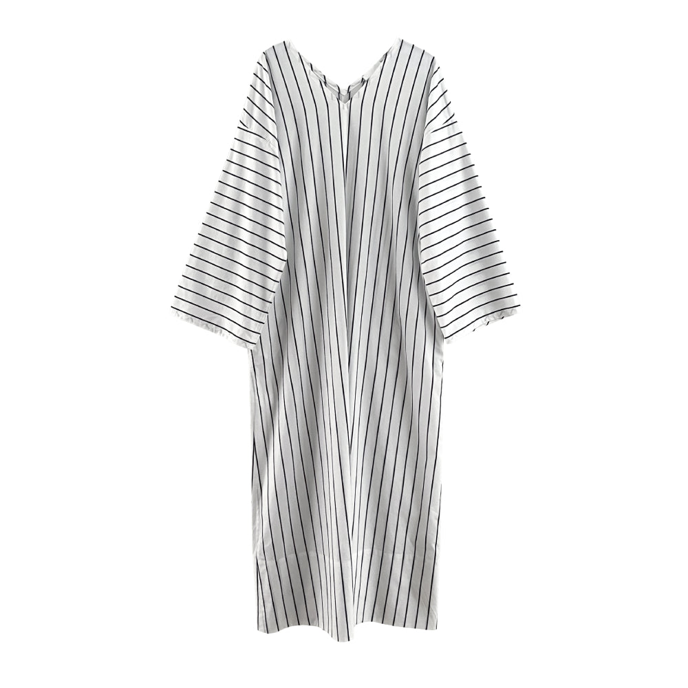 Discover the Aya Caftan at The Luxe Maison, featuring an airy, ankle-length poplin design, relaxed wide fit, side pockets, and front and back V-necklines.