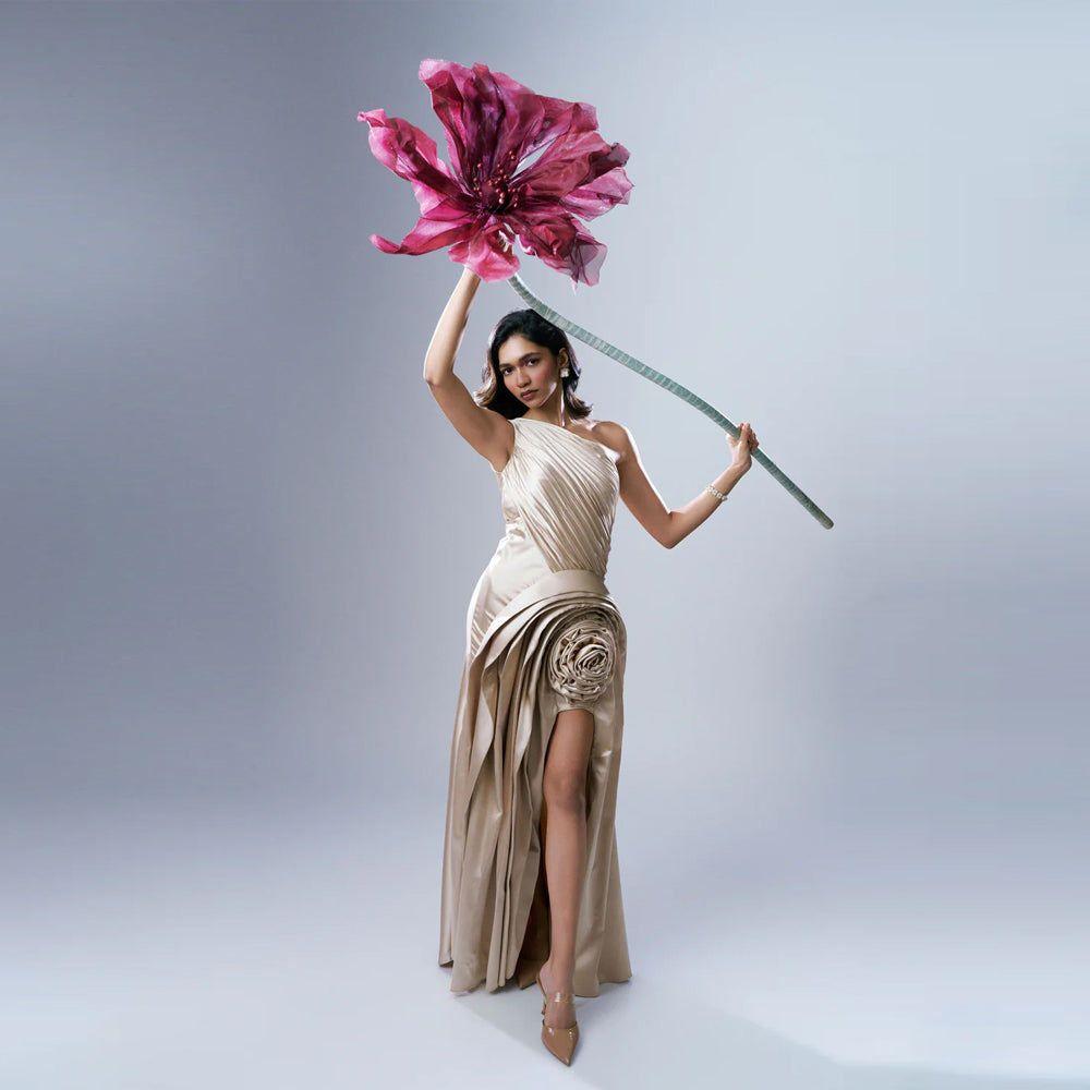 Soft gold satin one shoulder gown with pleats and slit, perfect for weddings. Shop online from our exclusive collection of premium styles.