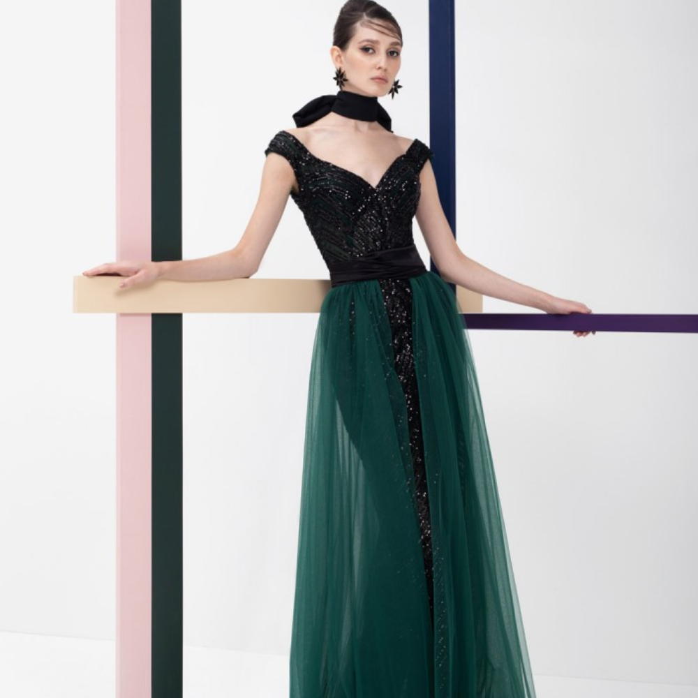 A unique Ready to wear dress. Black fully beaded sleeveless dress with V-neck and emerald green tulle overskirt.