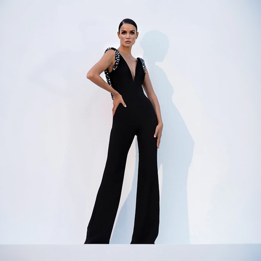 Black crepe jumpsuit with embroidered shoulders and back.