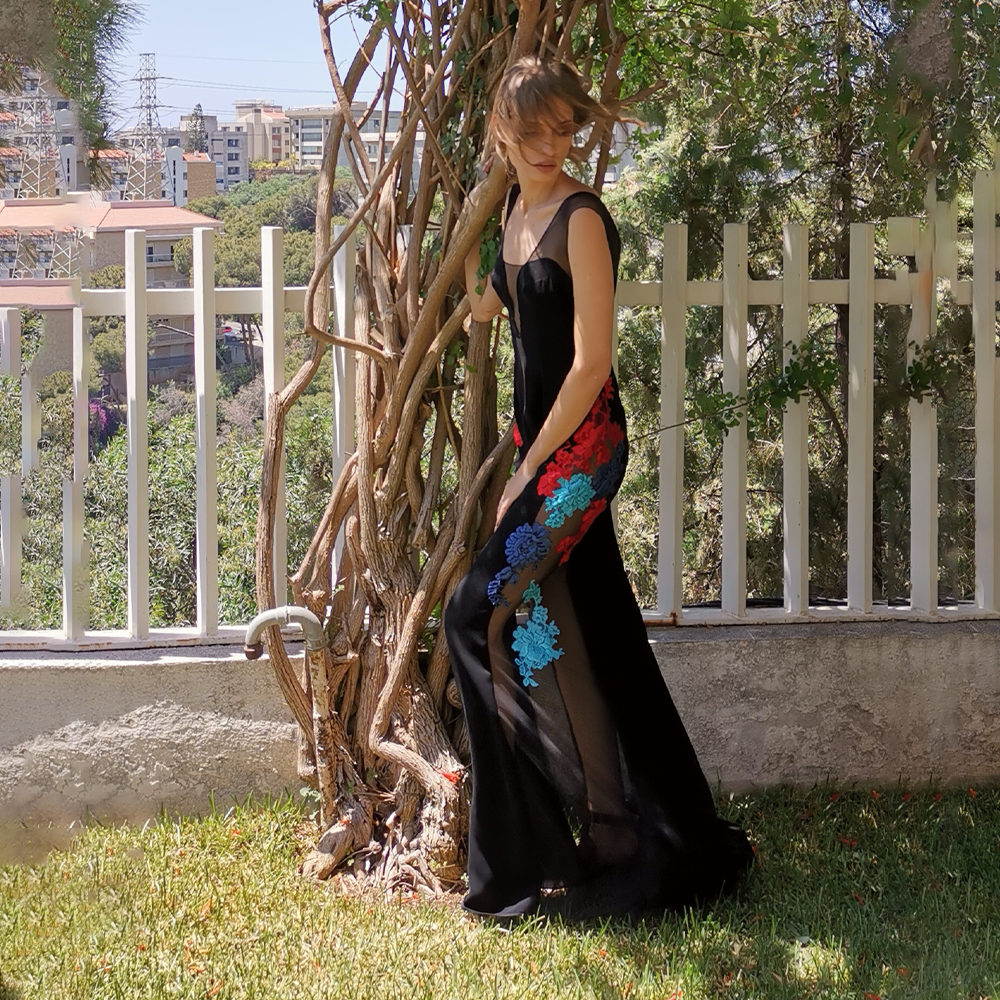 Black tulle and crepe dress with multicolor lace on the sides.