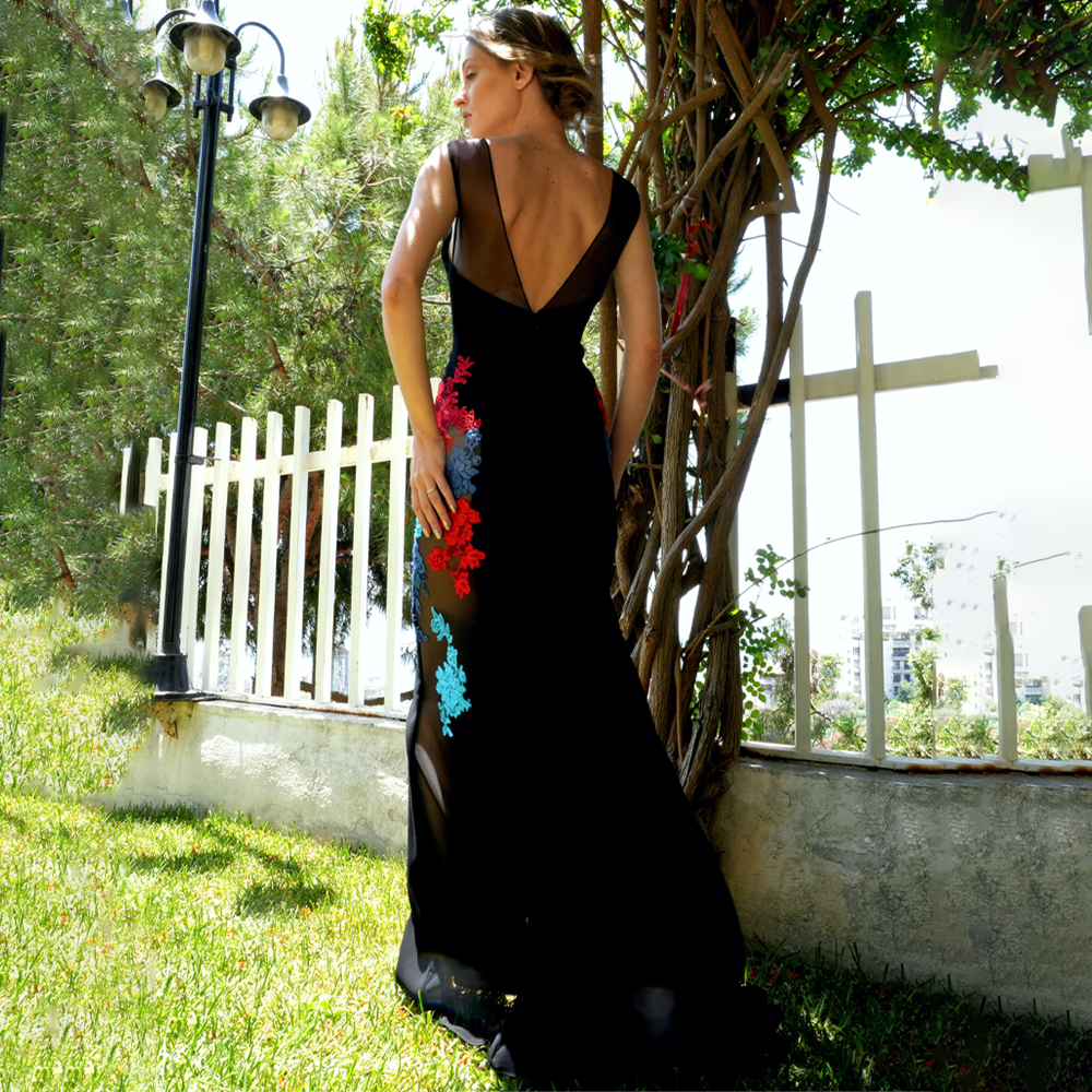 Black tulle and crepe dress with multicolor lace on the sides.