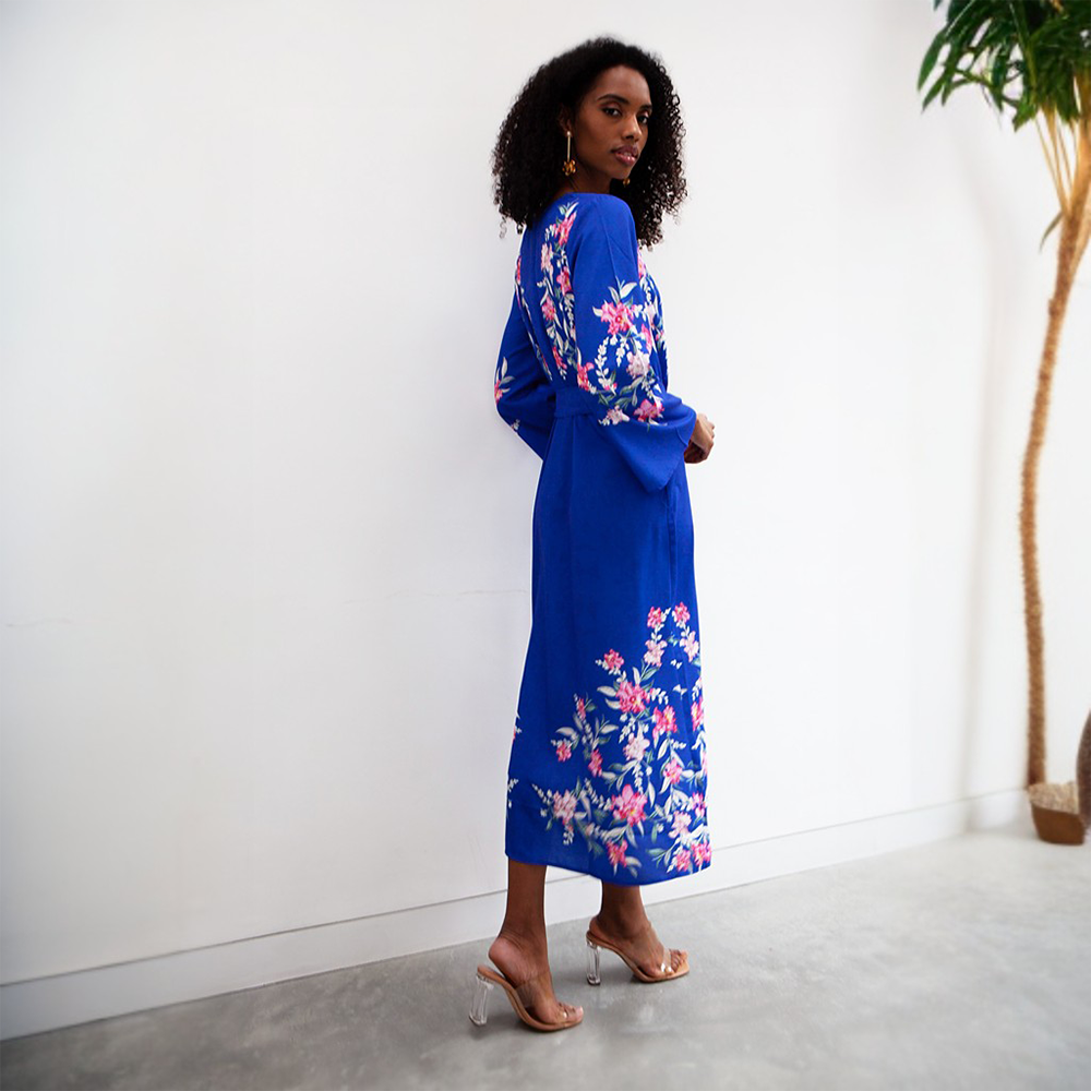 This vibrant blue midi dress features a V neckline, tie-up belt and full length sleeves.