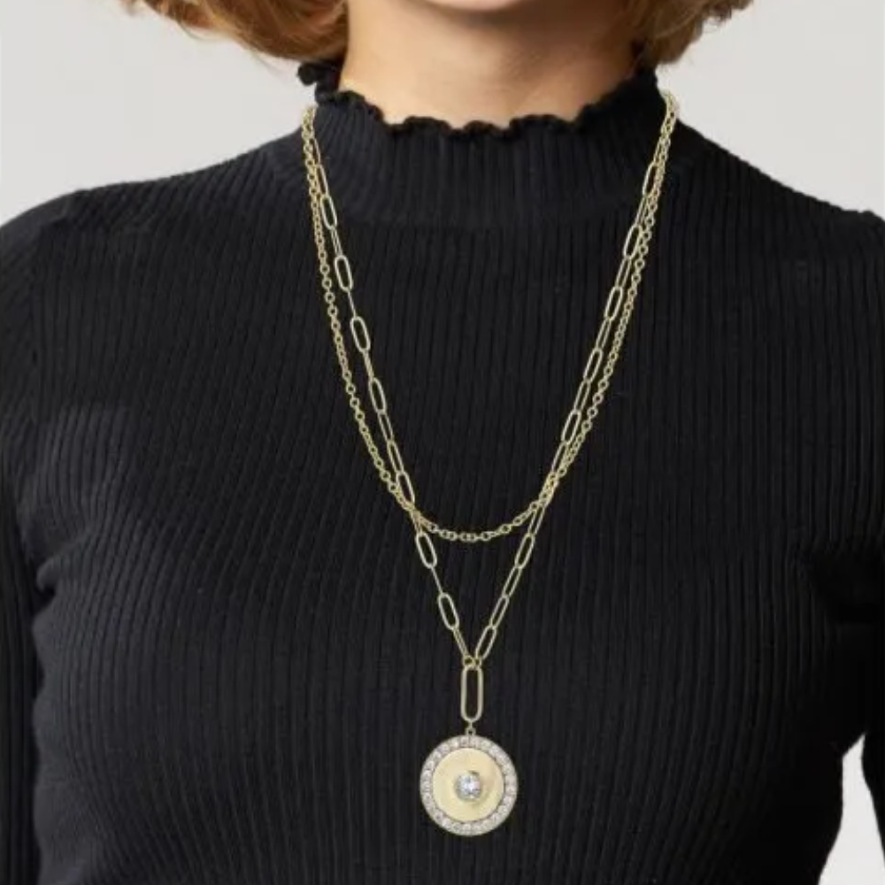 6 CTTW Round CZ Disc pendant necklace with double chain. Lobster clasp closure. Set in 18k gold plated brass.