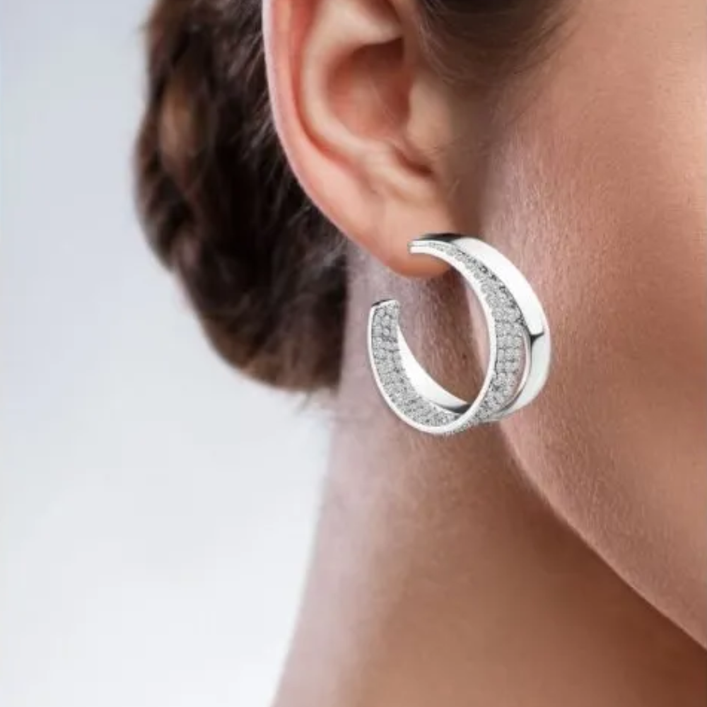 6 CTTW pave cubic zirconia and solid metal double hoop earrings. Earrings set in rhodium plated brass.