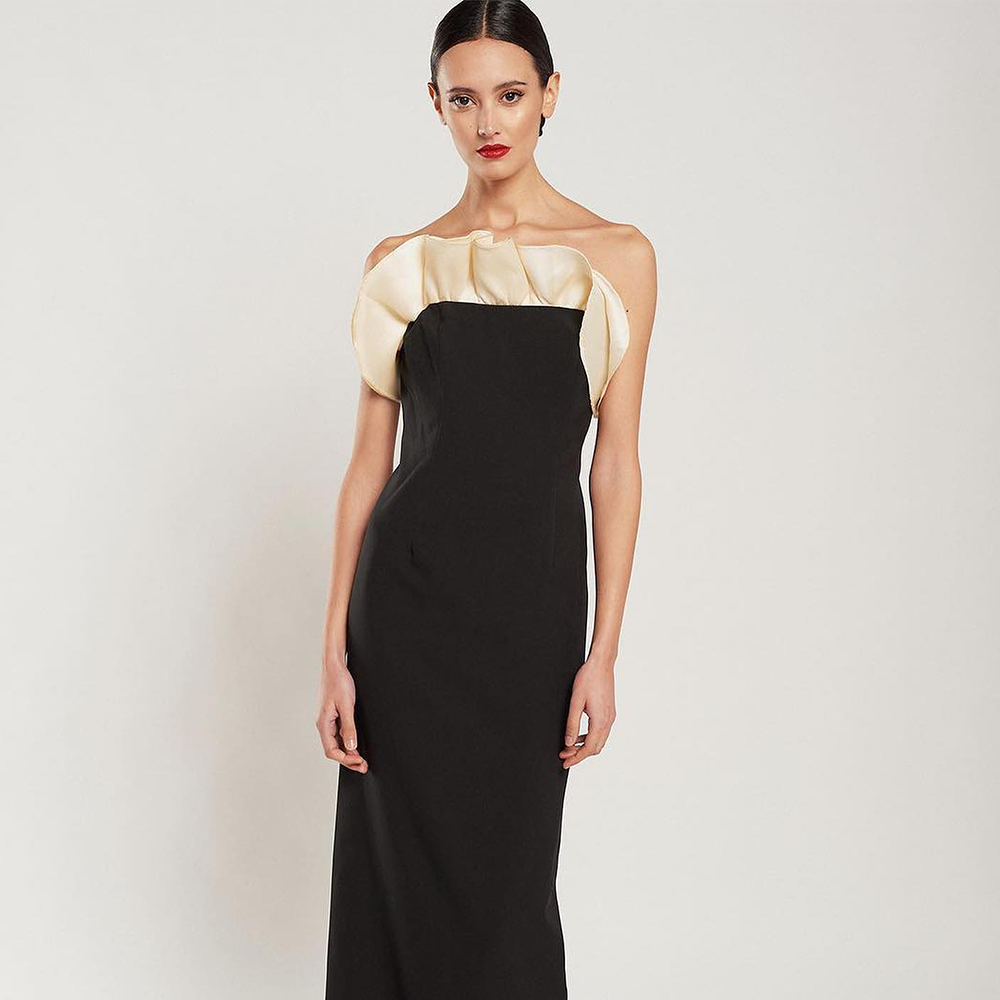 Explore the Callas Tussord black crepe dress with detachable train in off-white with a spectacular strapless neckline. Shop now!