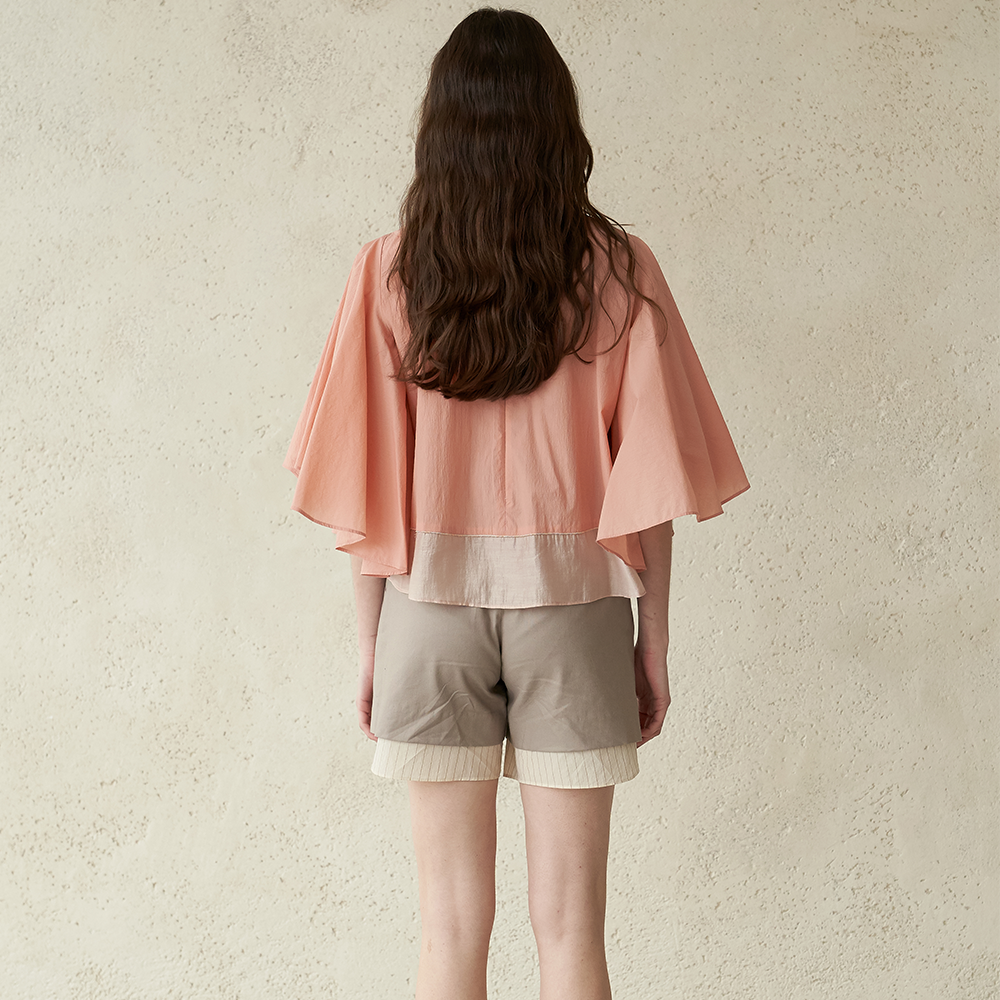 Light apricot colored winged blouse