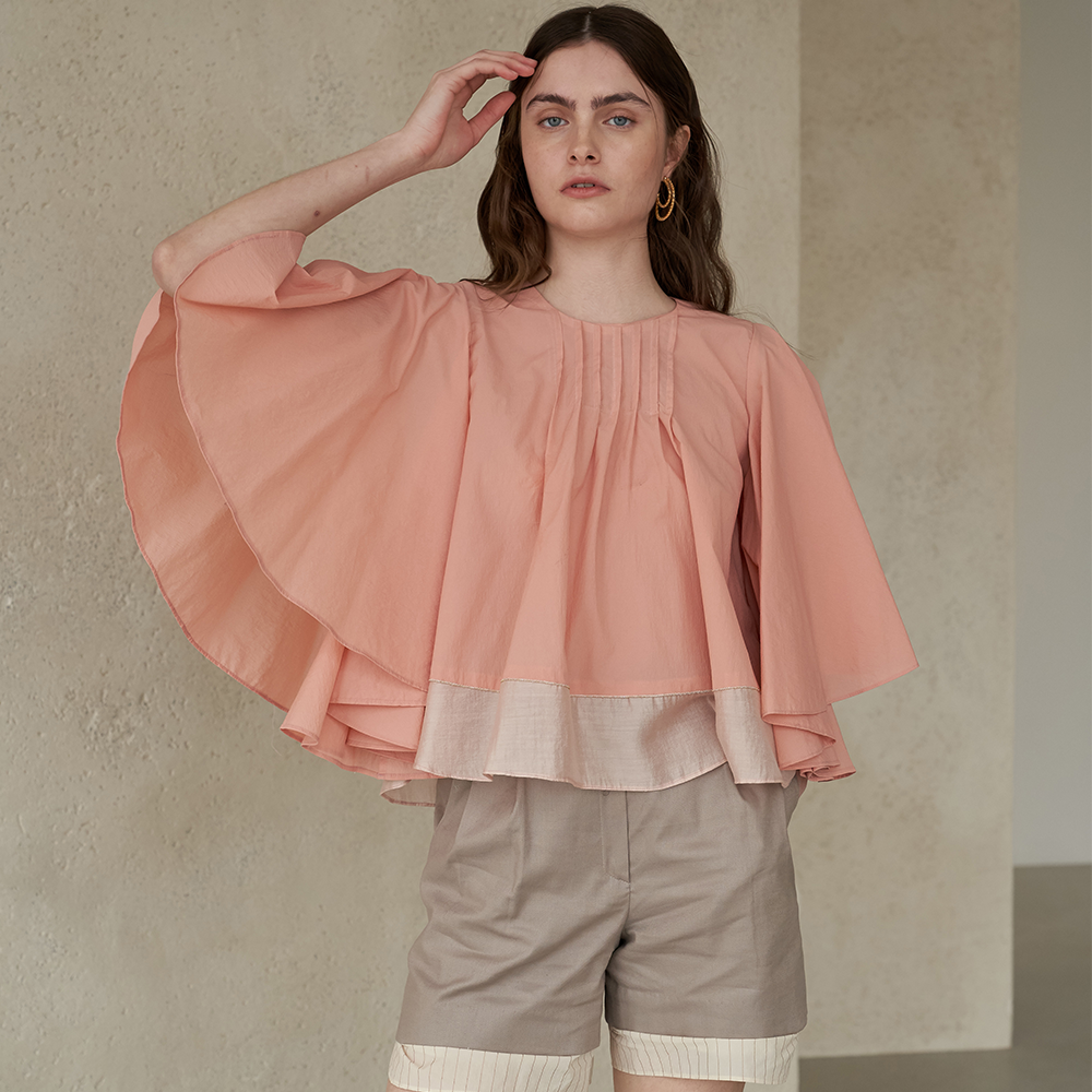 Light apricot colored winged blouse