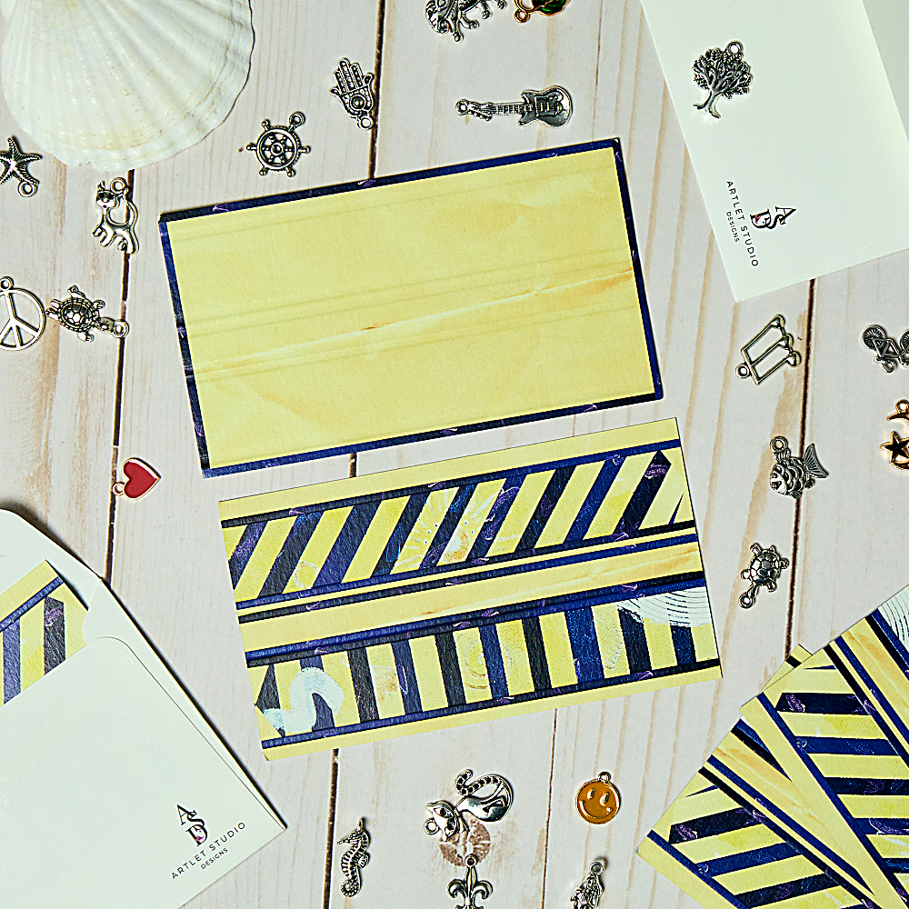 Discover Charm Pockets Envelopes at The Luxe Maison, featuring blue stripes, seven symbolic charms, and premium textured paper. Pack of 10, made in Dubai.
