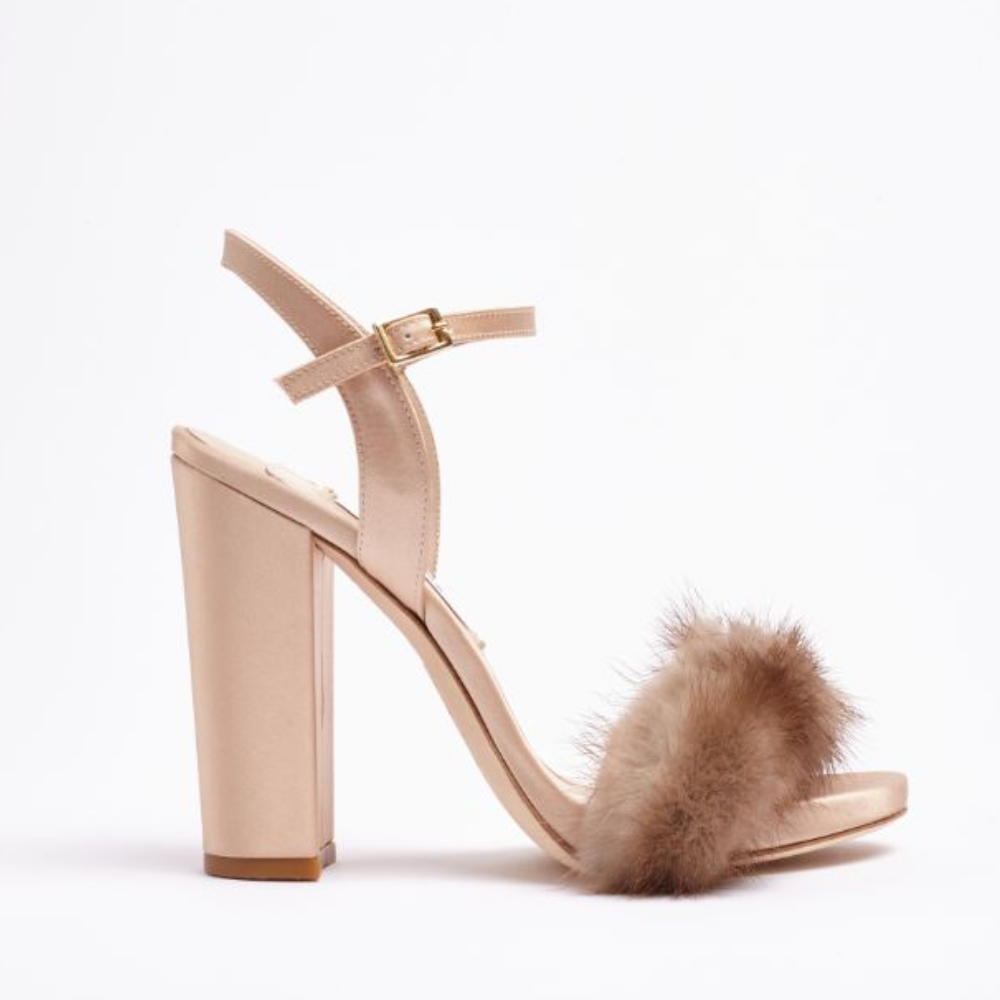 A modern open-toe sandal designed in pink satin. This style is decorated with a gorgeous mink trim.