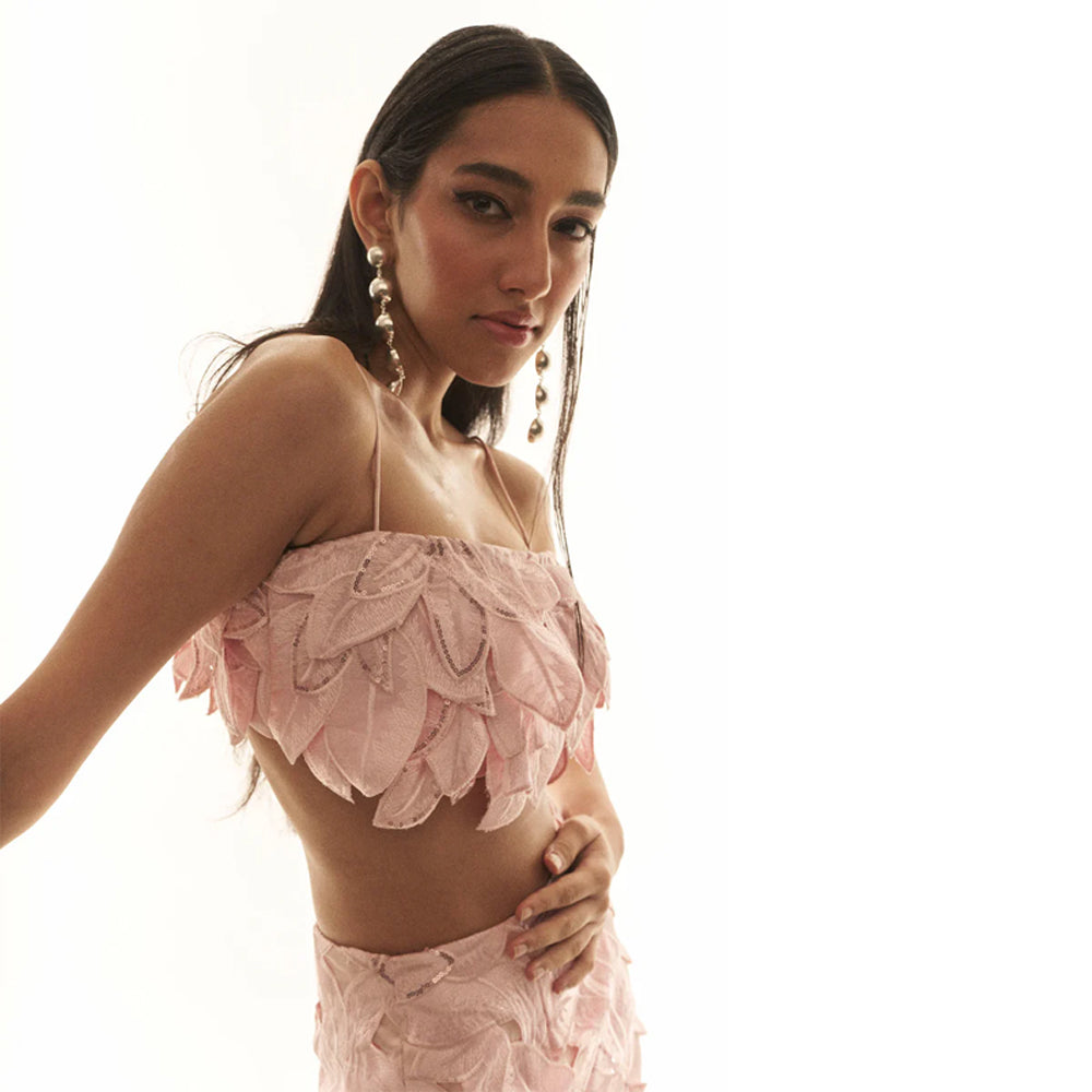 Pink bustier set with embroidered skirt and sequin detail, perfect for outings. Shop online from our curated edit of premium fashion.