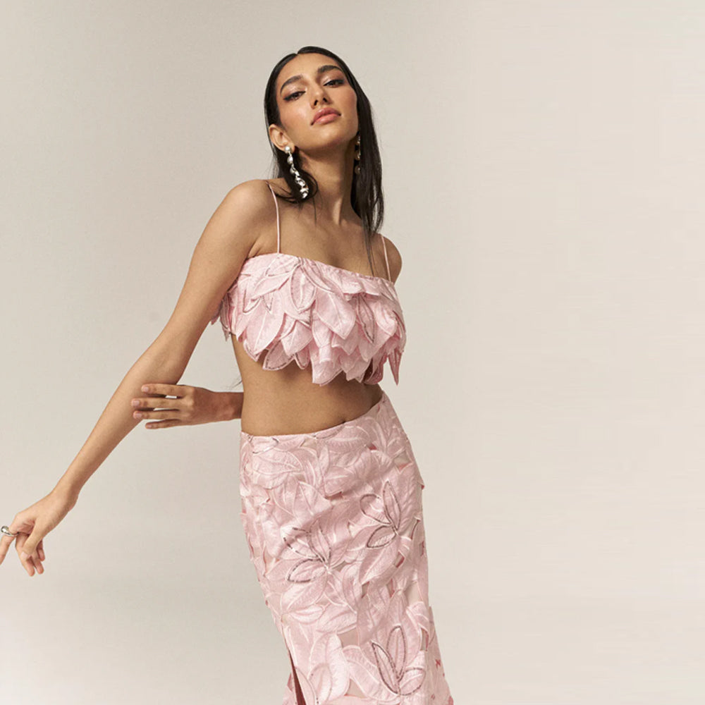 Pink bustier set with embroidered skirt and sequin detail, perfect for outings. Shop online from our curated edit of premium fashion.