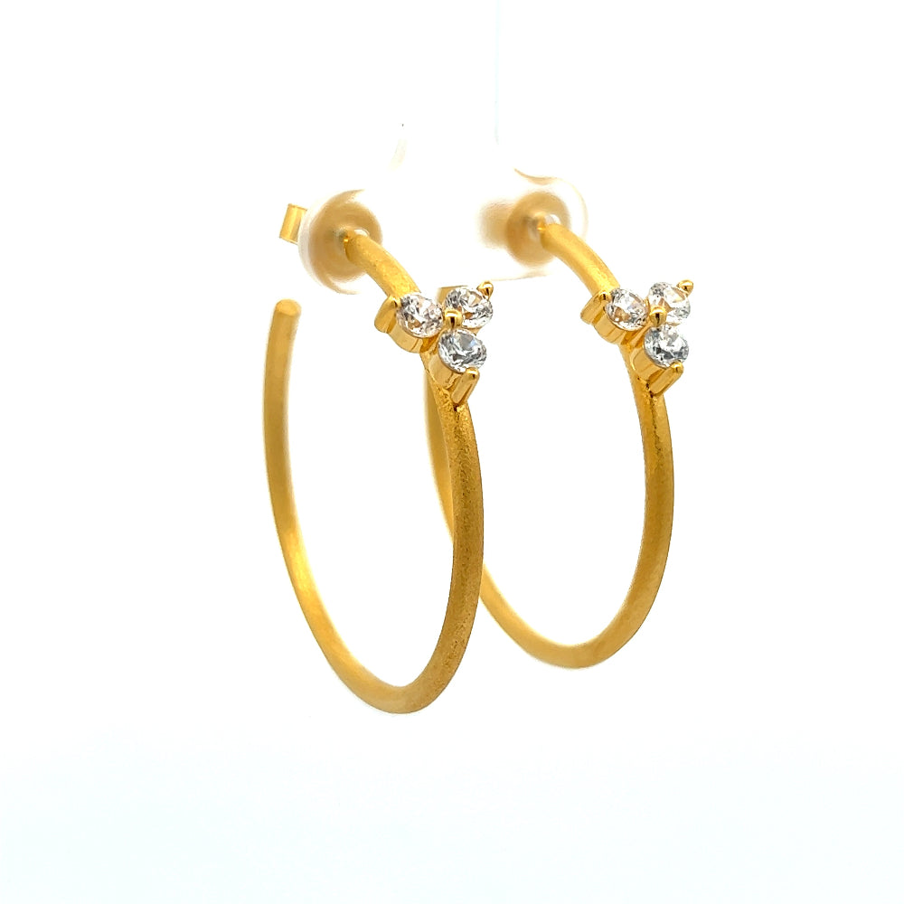 Shop online premium 18K gold open C hoop earrings with cubic zirconia clover detailing.