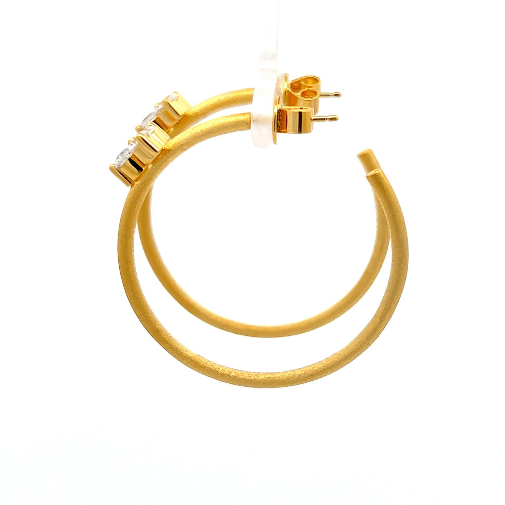Shop online premium 18K gold open C hoop earrings with cubic zirconia clover detailing.