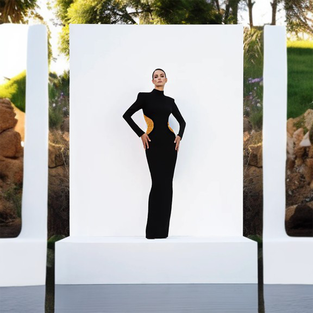 Black crepe dress with gold chains.