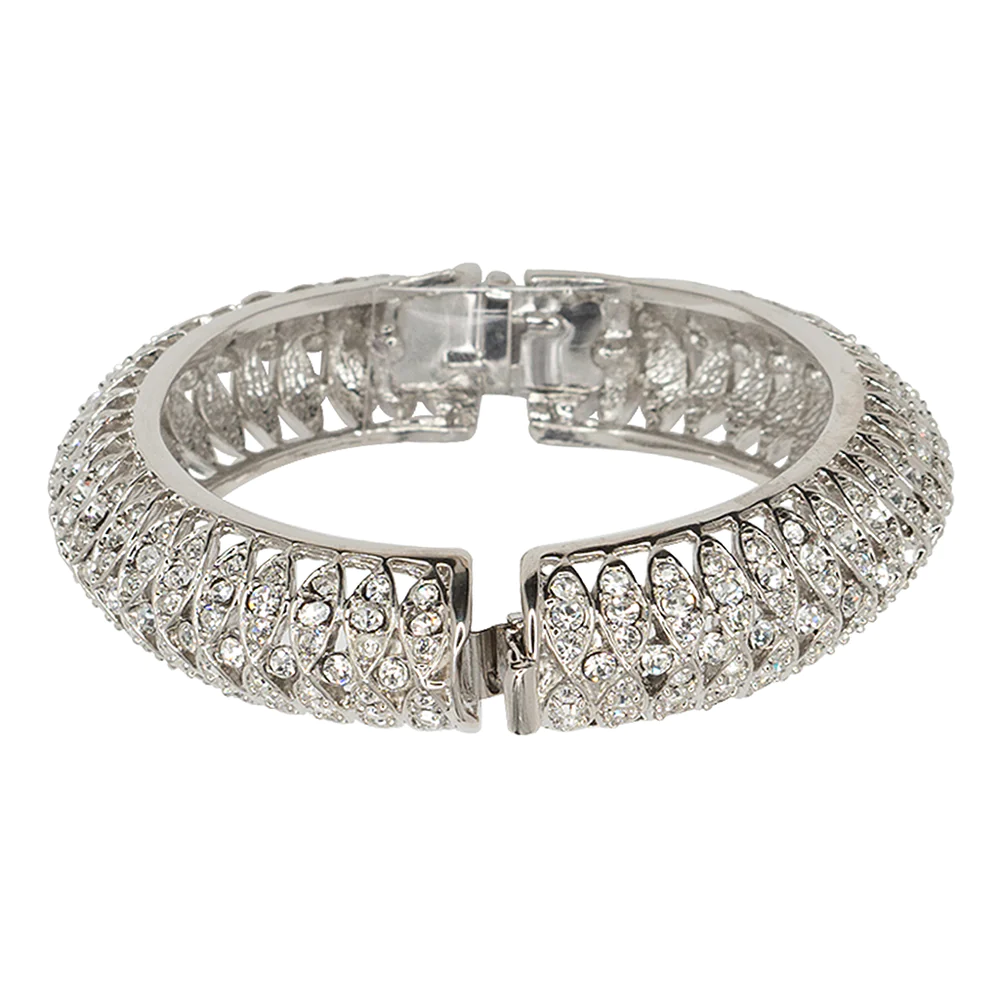 A Jackie Onassis original, this silver bangle with bright pave crystals will glimmer and shine on your wrist. 