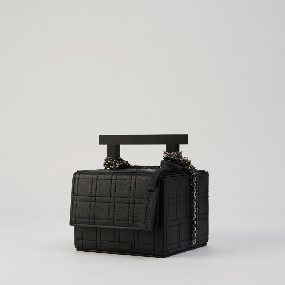 Leather handbag with chain straps and magnetic closure, perfect for daily use. Shop online from our curated edit of premium fashion.
