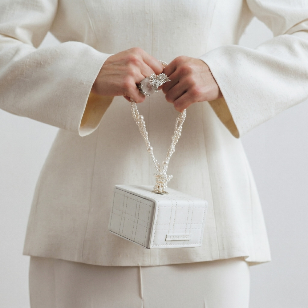 Leather handbag with Swarovski pearl handle and magnetic closure. Shop online from our curated edit of premium fashion.