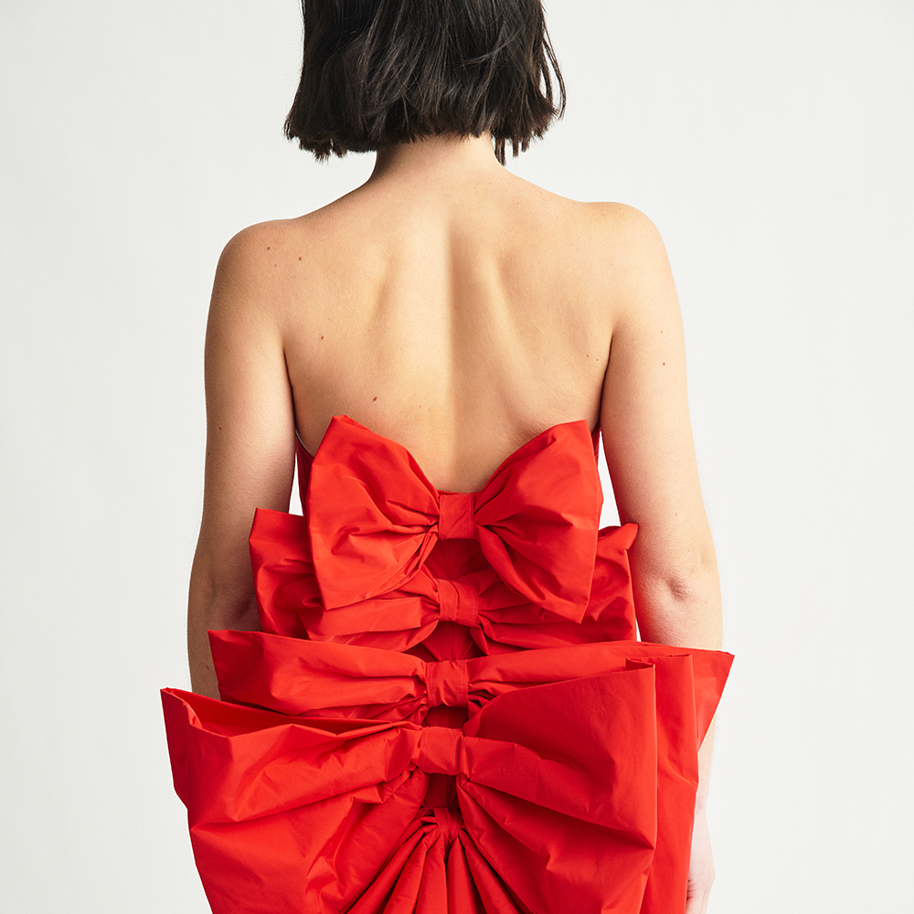 Shop the Cuquismo Dress in red taffeta with handmade bows and train in the back. Perfect for evening and party wear. Shop now!