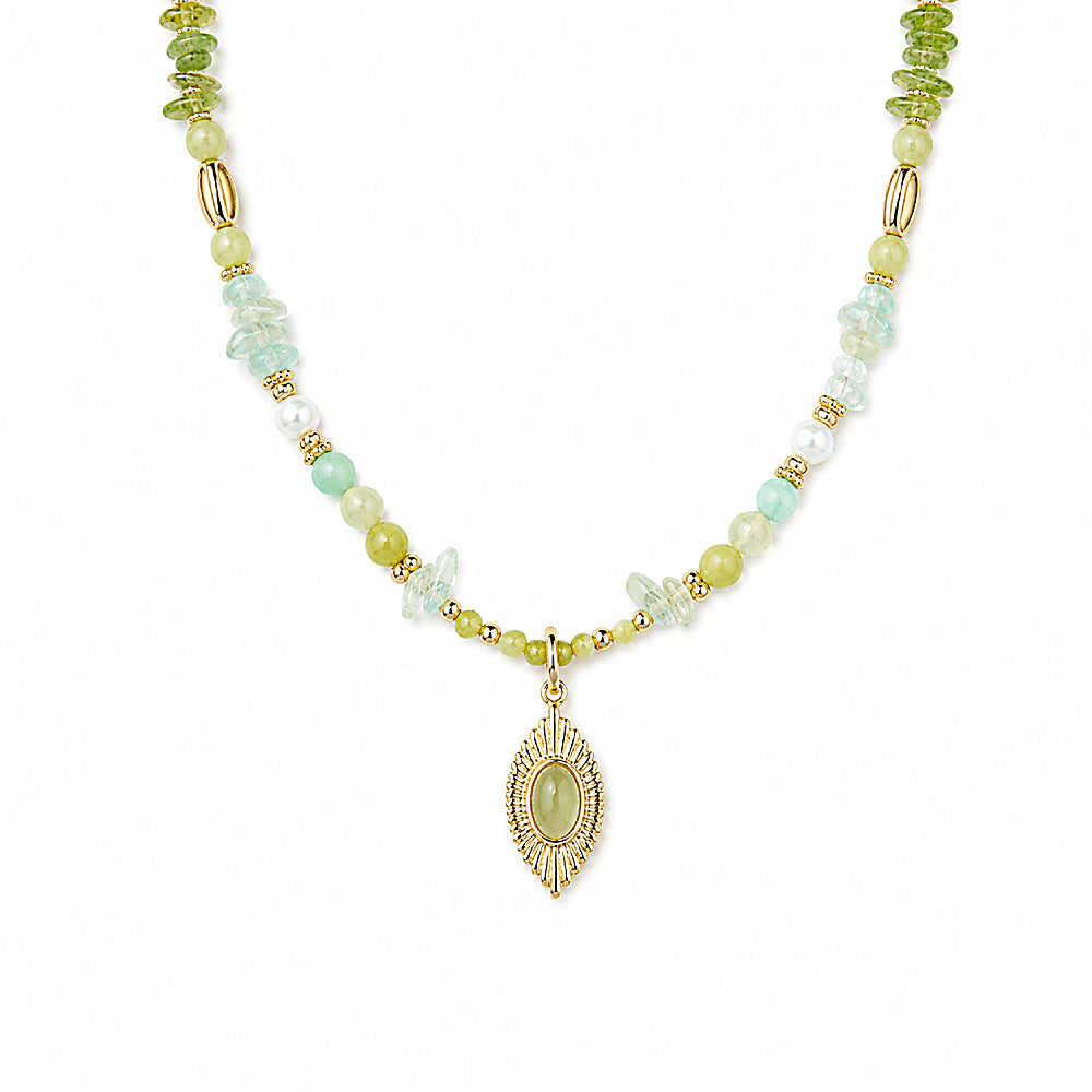 Discover the Daphne Green Gemstone Necklace at The Luxe Maison, featuring freshwater pearls, prehnite, peridot, green aventurine, Xiuyan jade, and Alxa agate in harmonious forest-green hues. Finished with a radiant golden talisman pendant, this handcrafted necklace celebrates nature, renewal, and timeless elegance.