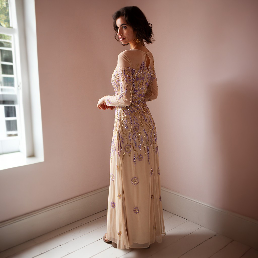 The Darla Gown is a nude floor-length gown with gold and lilac floral beading.