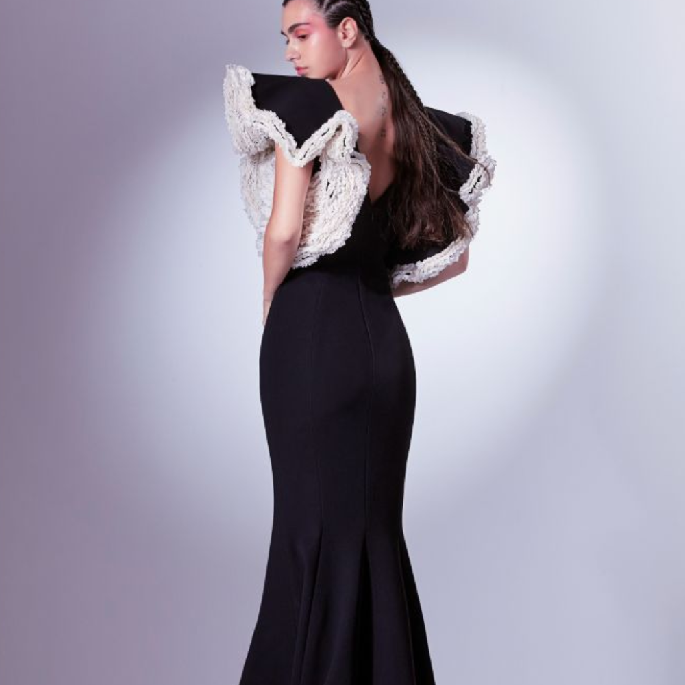 This dramatic deep V dress is crafted in a mermaid silhouette and rendered in black and white.