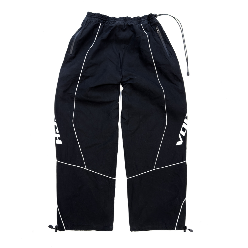Shop online from our exclusive website and discover the Delta Track Pants by Voitech®, crafted from lightweight technical nylon with an engineered silhouette for futuristic streetwear.