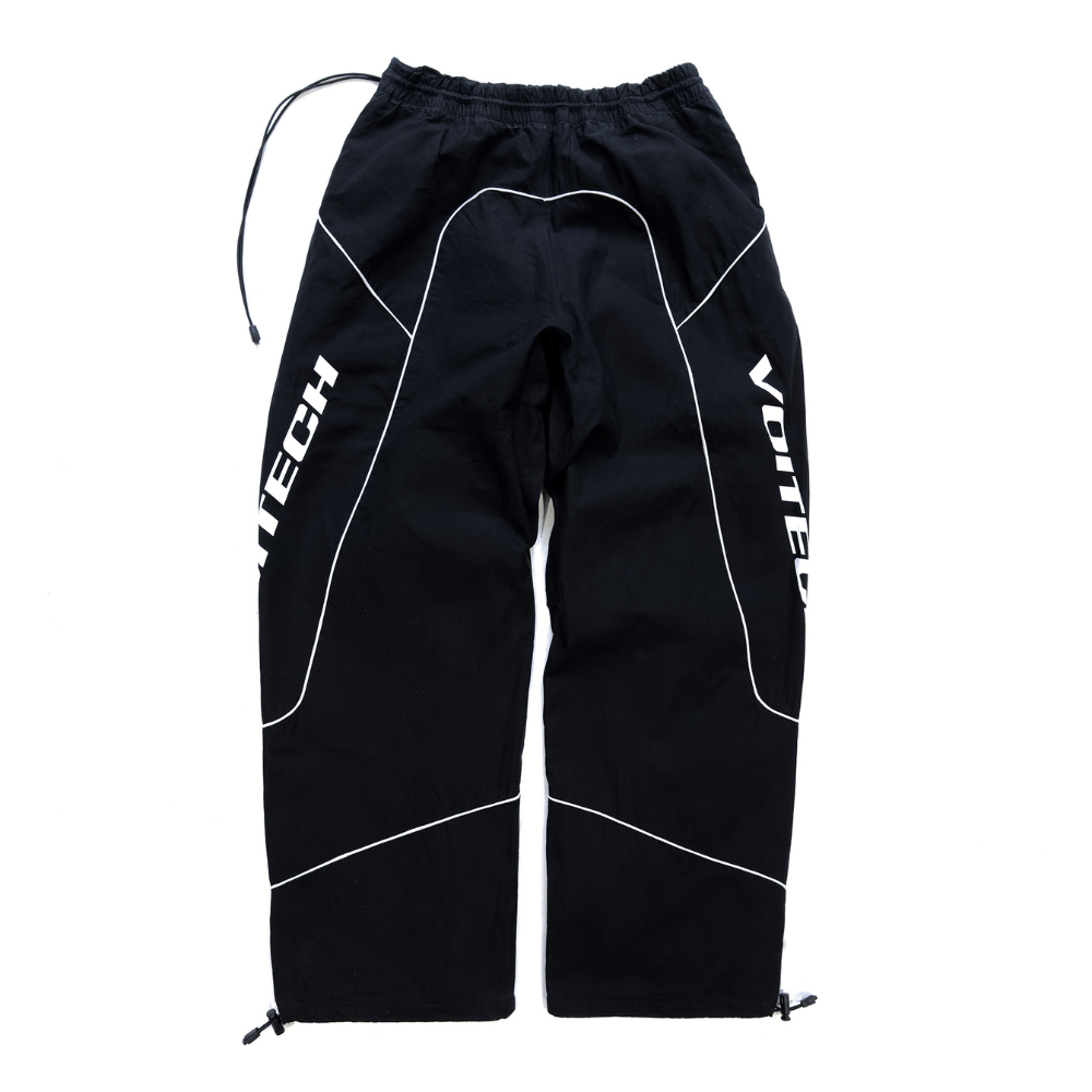 Shop online from our exclusive website and discover the Delta Track Pants by Voitech®, crafted from lightweight technical nylon with an engineered silhouette for futuristic streetwear.