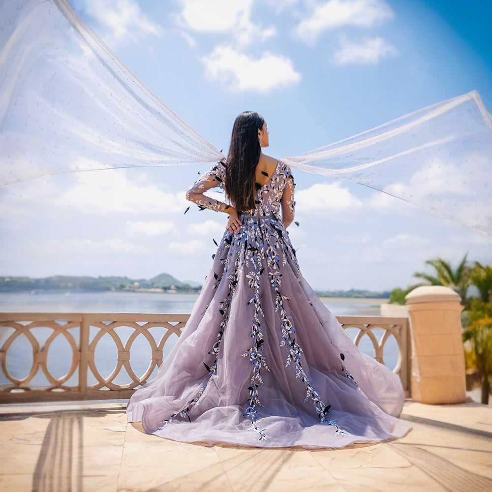 Monochromatic Theme embroidery with feathers, wrap around bustle with train gown.